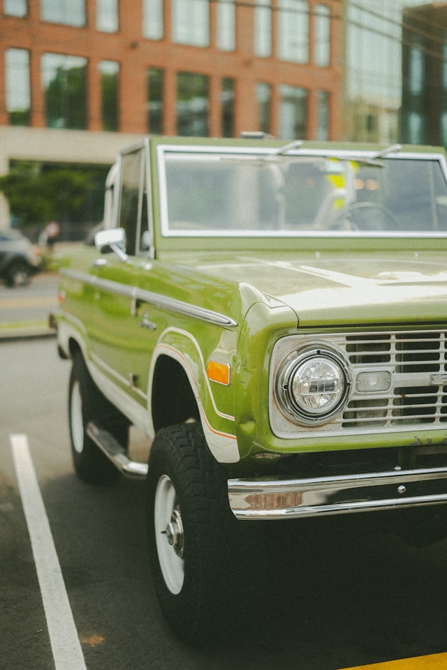 A picture of an old green car.