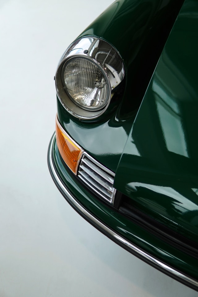 A picture of an old green car.